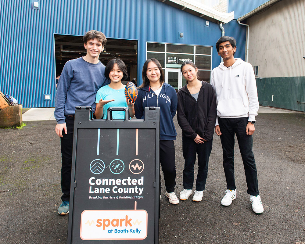 Connected-Lane-Horizontal Group photo of Connected Lane County youth with sign