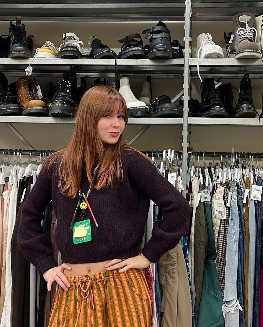 IMG_1464 Buffalo Exchange employee in front of clothing rack