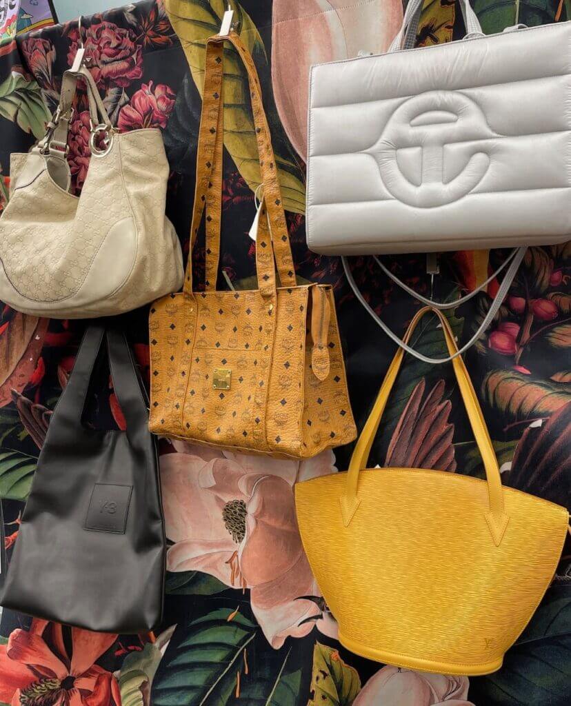 colorful hanging purses on store rack