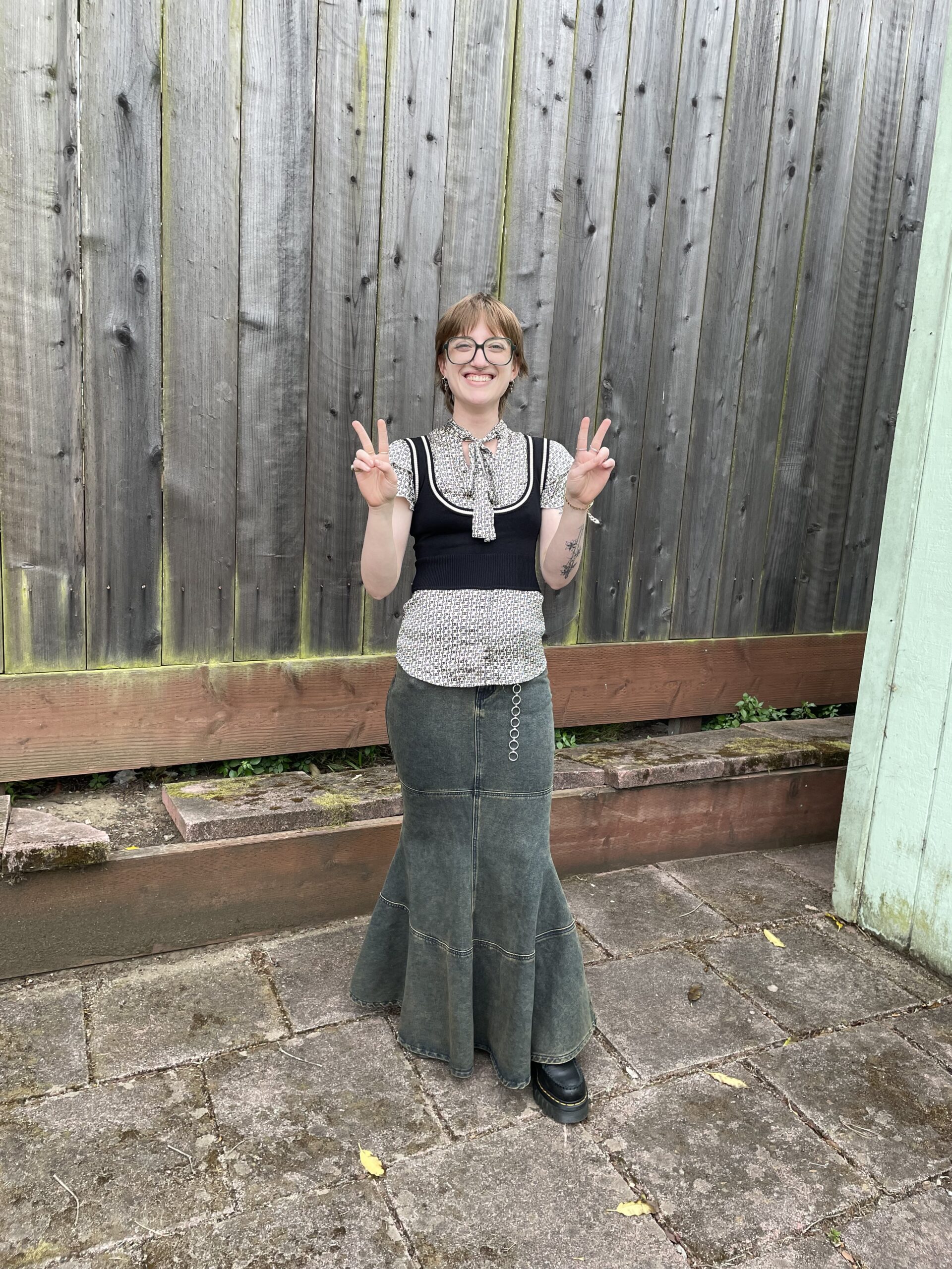 IMG_1086 Employee Izzy holding up double peace signs