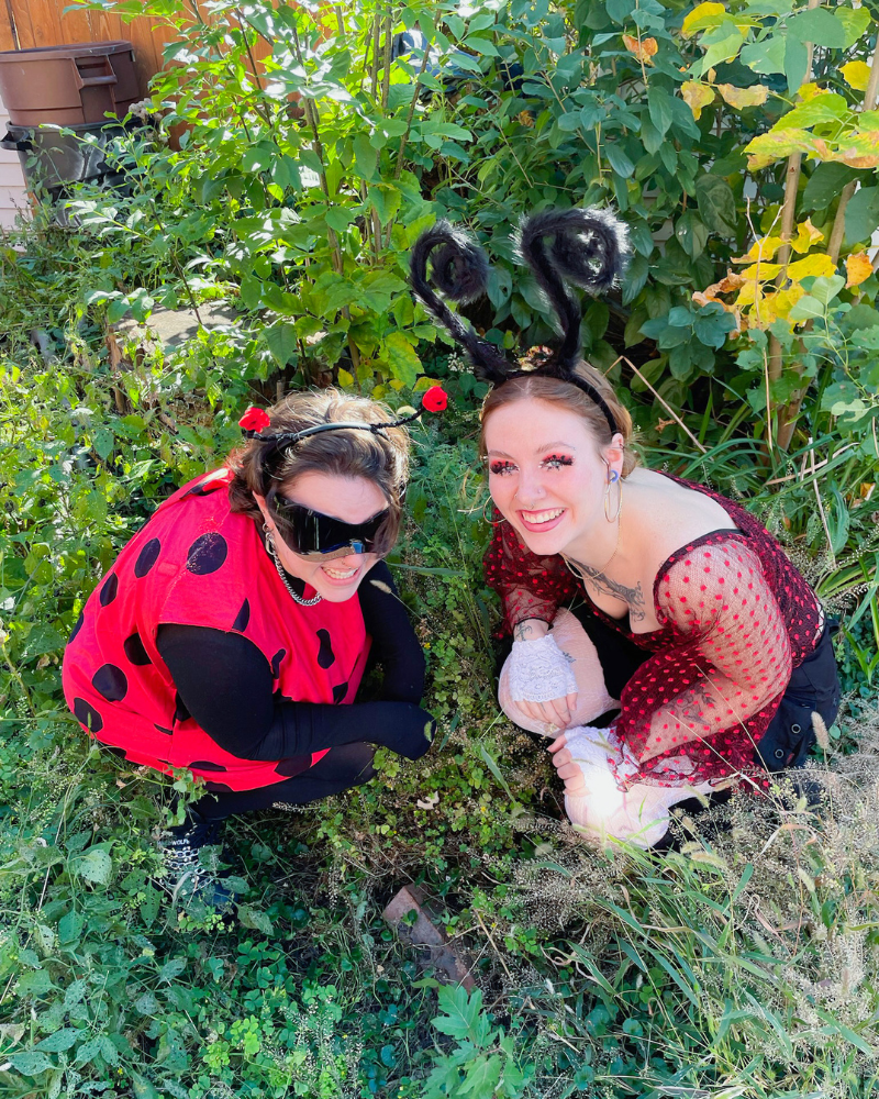 5 Two Buffalo Employees in polka dots with bug antennae crouching in grassy area.