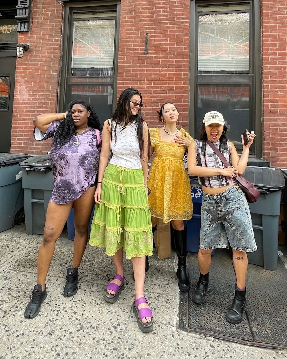 Four stylish people standing in front of Buffalo Exchange