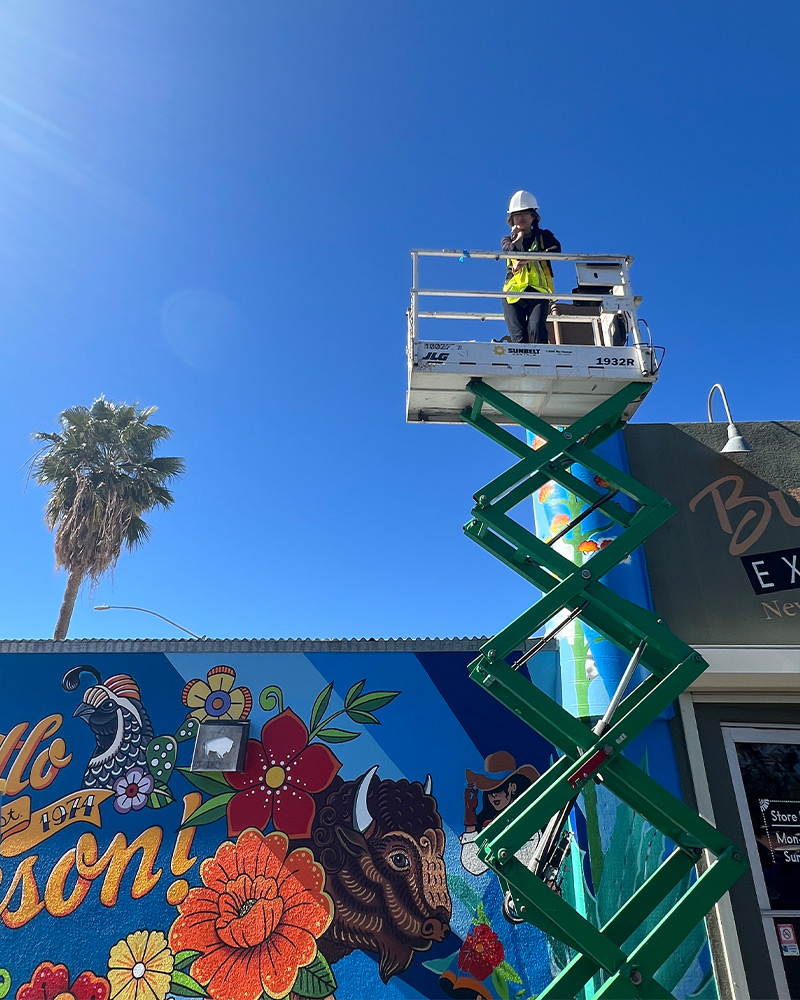 Three generations of the Block family pose for photo near Buffalo Exchange Tucson store sign
