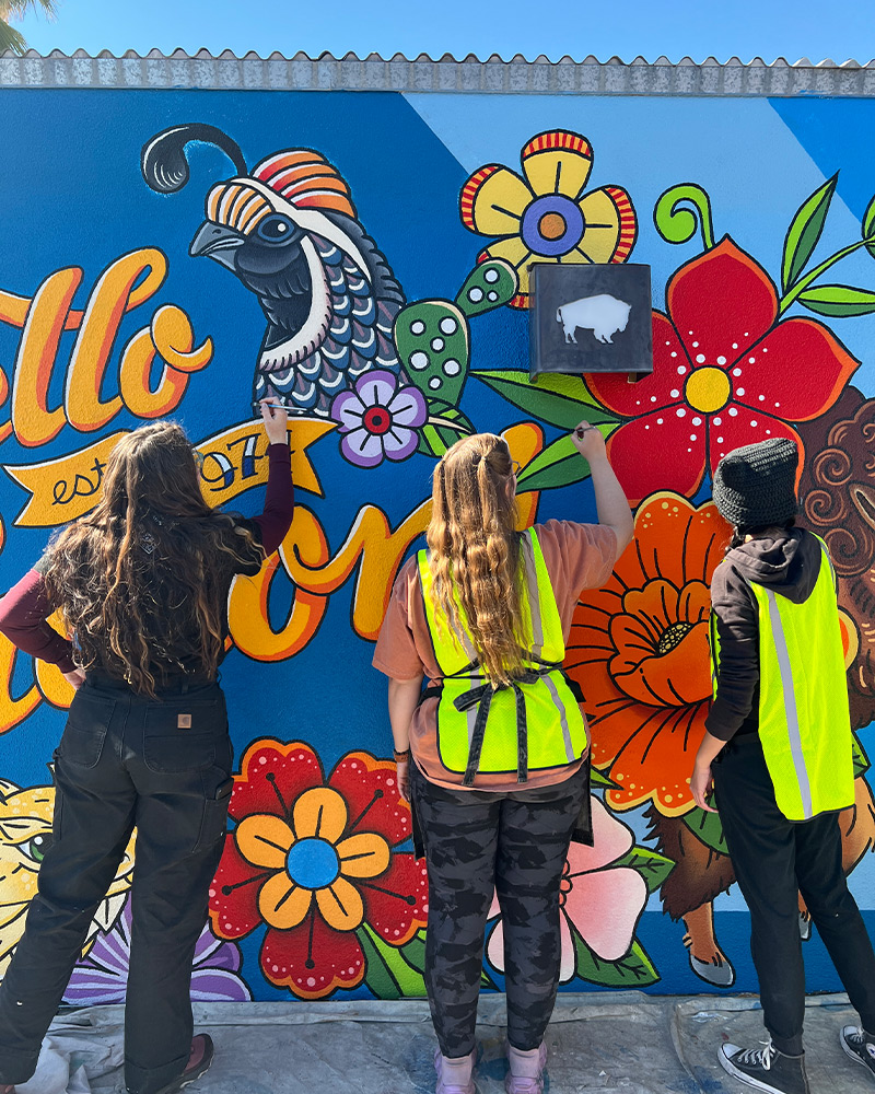 Three generations of the Block family pose for photo near Buffalo Exchange Tucson store sign