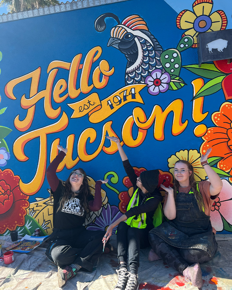 Three generations of the Block family pose for photo near Buffalo Exchange Tucson store sign