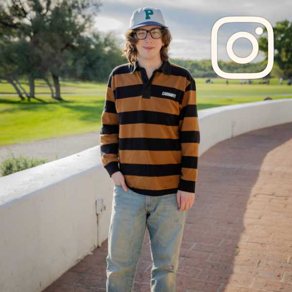 Person in a contemporary outfit of a Pirates baseball hat, striped Carhartt rugby polo, light wash jeans and color-tinted sunglasses. Instagram logo overlay at top.