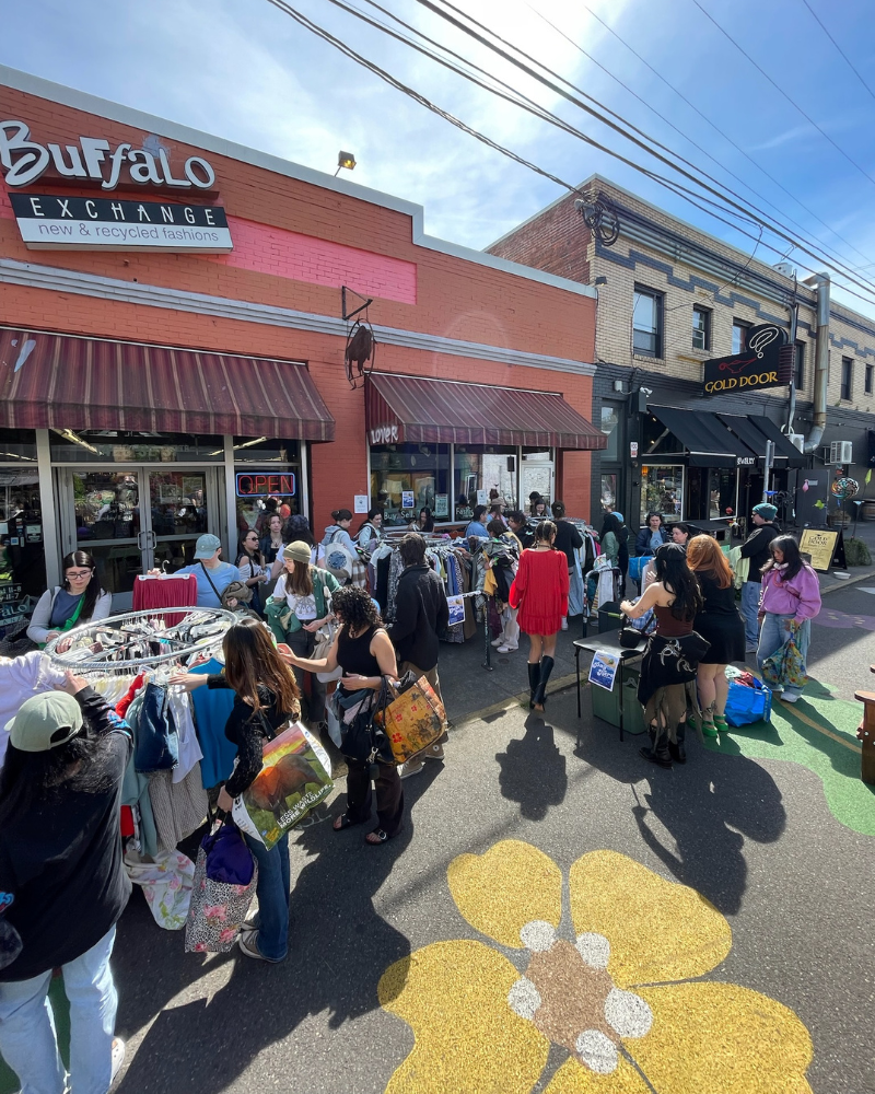 Crowd shopping the $1 Sale outside of a Buffalo Exchange store