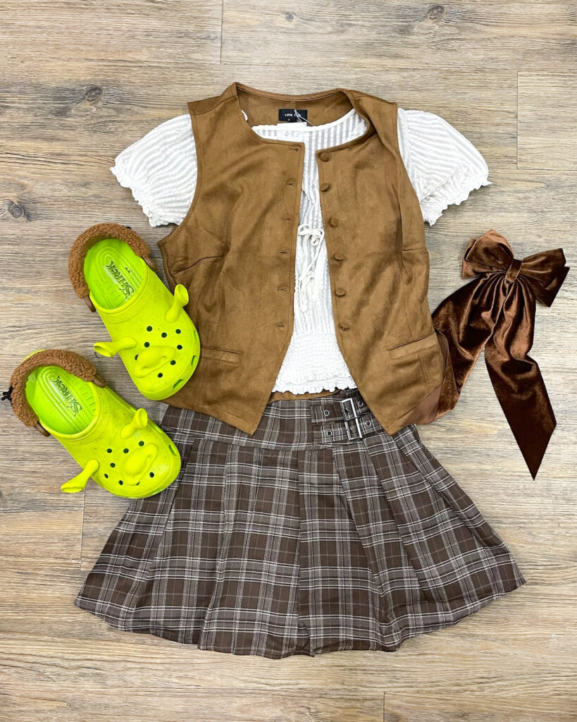 A flat lay of a Shrek costume composed of pieces thrifted from Buffalo Exchange.